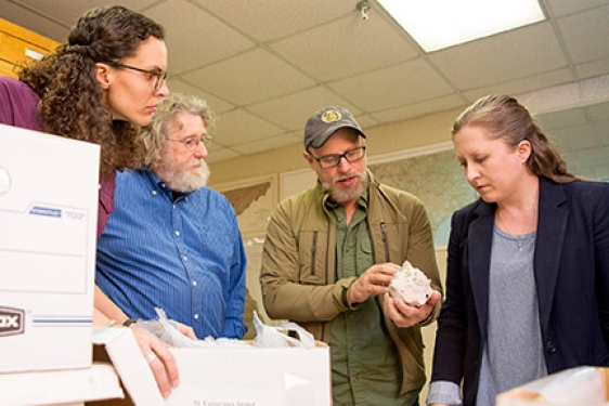 four people with shell, interior photo