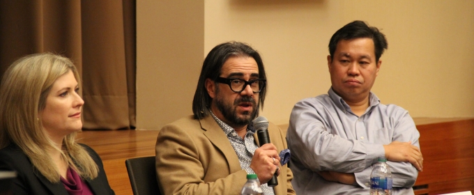 photo of three people, one holding microphone