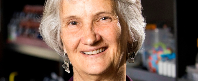 photo of woman with lab shelving in background