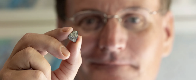photo of man holding rock in foreground