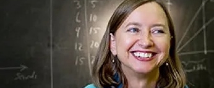 photo of woman, with blackboard in background